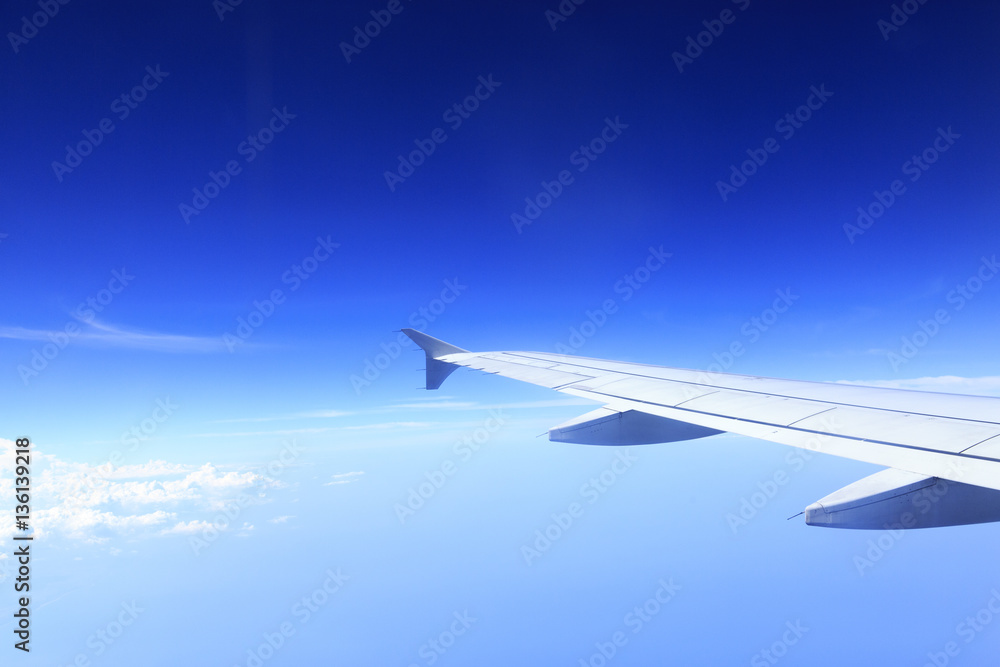Fototapeta premium Skyline View above the Clouds from air plane
