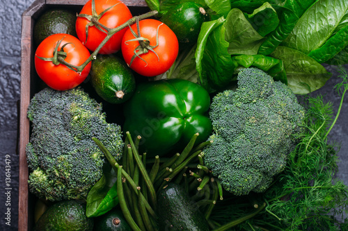 Food background of green vegetables broccoli romaine lettuce celery pepper zucchini on black table Healthy lifestyle Top view Copy space