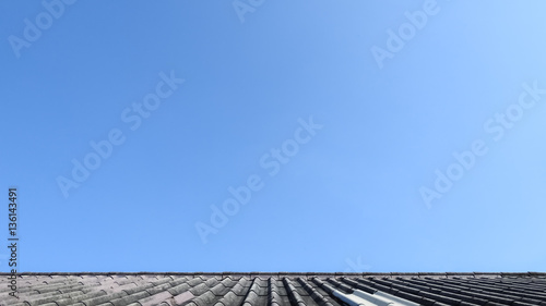 Clear blue sky above the old rooftop