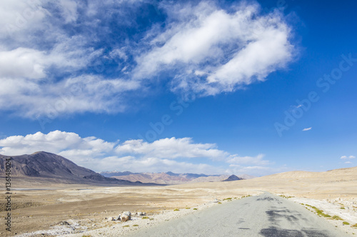 Empty dirty off road in Pamir Mountains in Gorno-Badakhshan Autonomous Region, Tajikistan