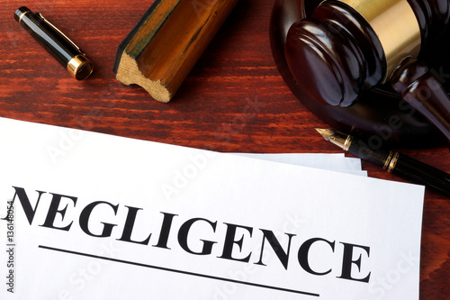 Negligence form, documents and gavel on a table.