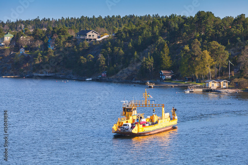 Yellow Ro-Ro cargo ship crossing the bay