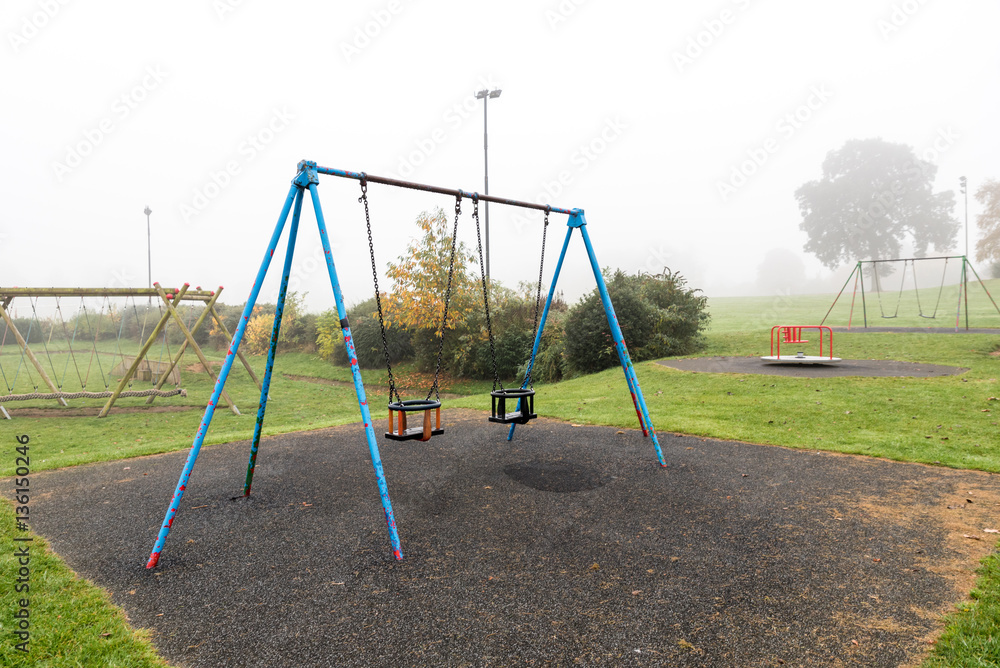 Early morning view of empty playground with fog around it Early morning view of empty playground with fog around it