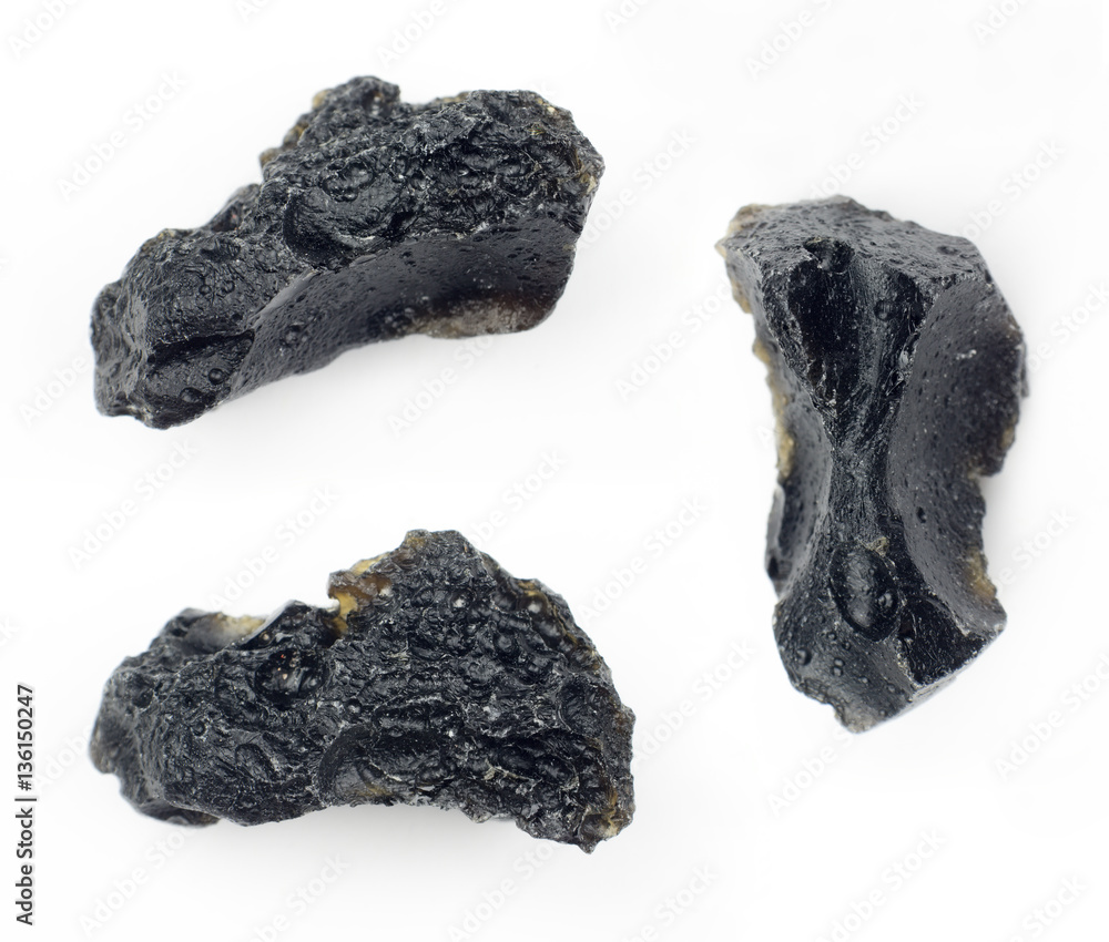 Black tektite on a white background. Black tektite on a white background.