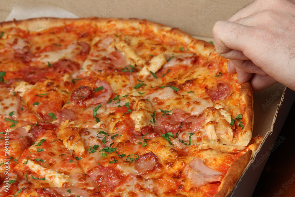 In the hand a slice of pizza. Closeup. In the hand a slice of pizza. Closeup.