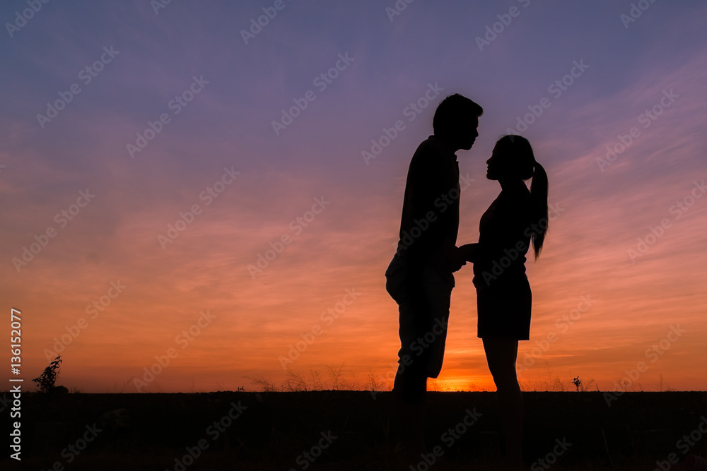photograph silhouette,Young men and young women Show your love during sunset,vintage tone.