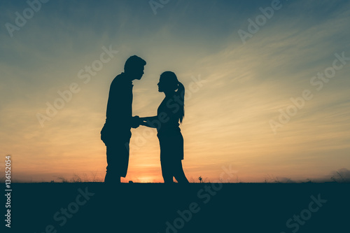 photograph silhouette,Young men and young women Show your love during sunset,vintage tone.