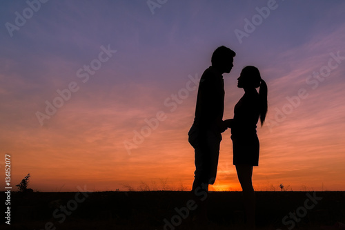 photograph silhouette,Young men and young women Show your love during sunset,vintage tone.