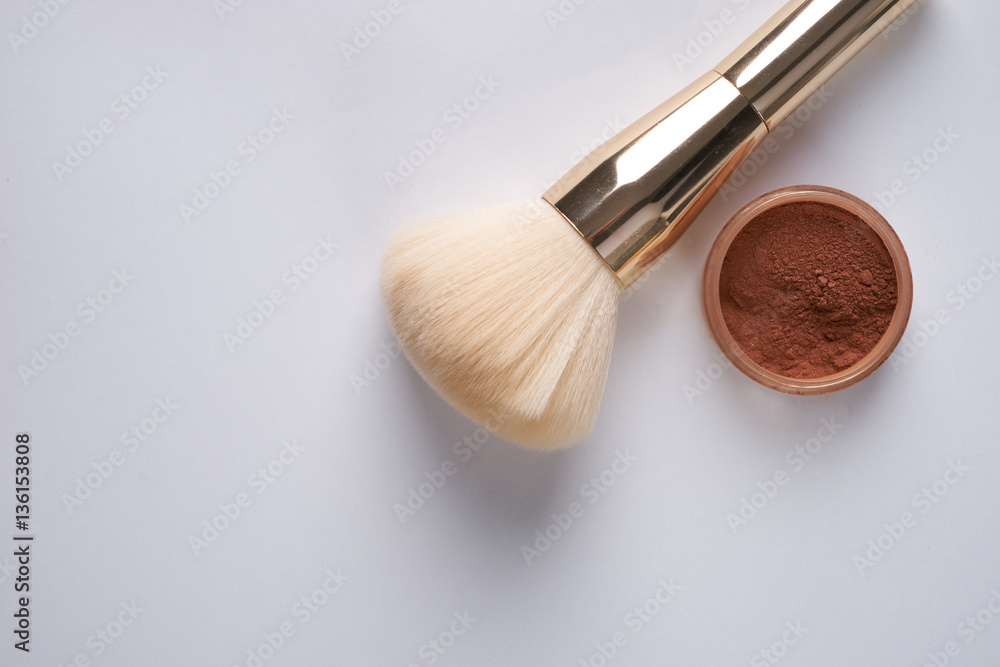 Face powder and brush isolated on white background, top view with copy space. Face powder and brush isolated on white background, top view with copy space.