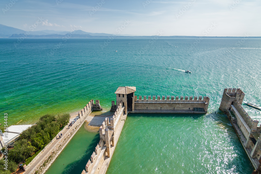 Sunny view of castle Rocca di Sirmione at Garda lake, Lombardia region, Italy.