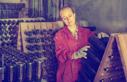 Wine maker taking care of seasoning bottles