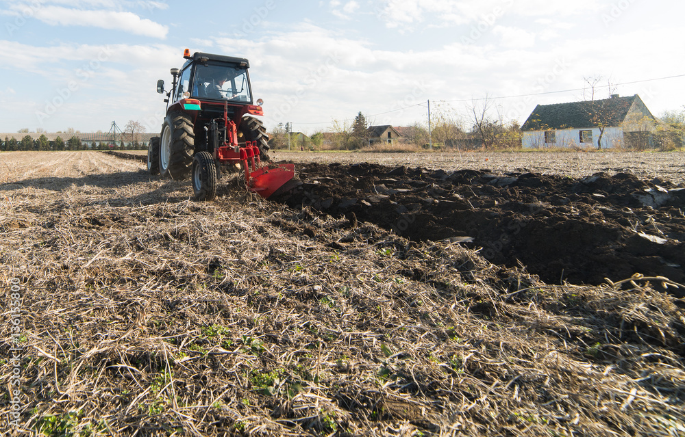 Fototapeta premium Tractor preparing land for sowing