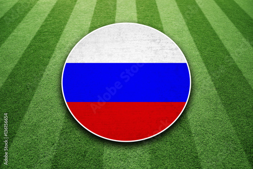 Sunny soccer green grass pattern field with textured Russia flag background.
