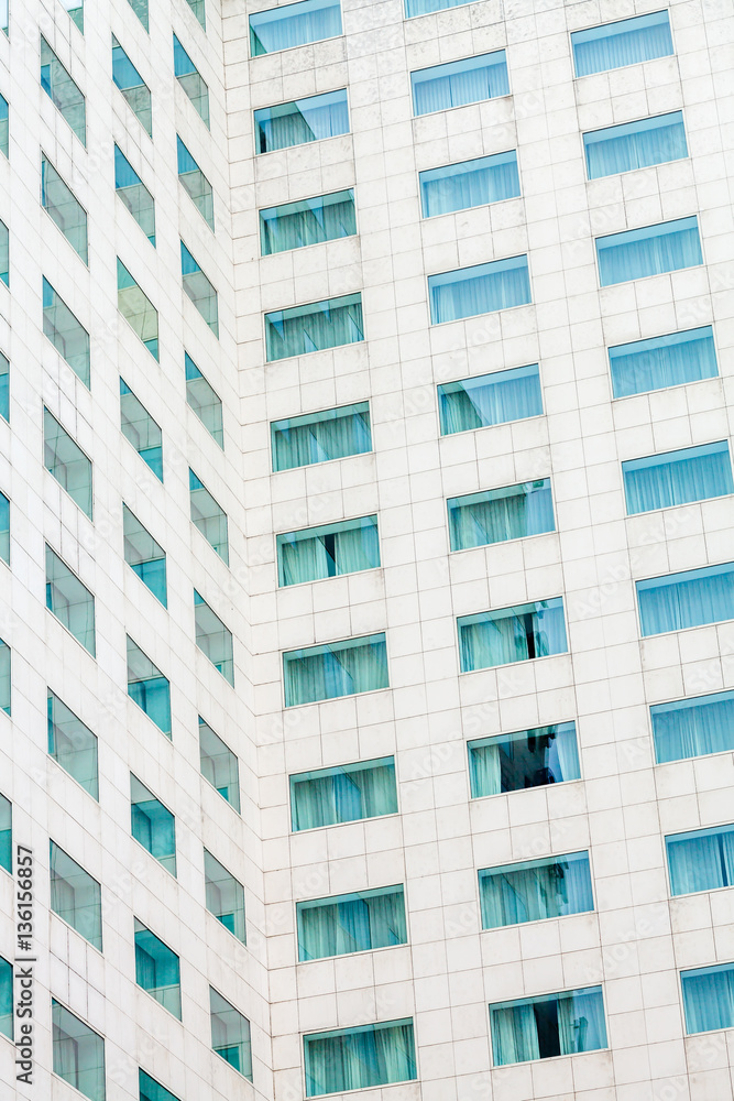 Modern concrete building facade with square glass windows Modern concrete building facade with square glass windows