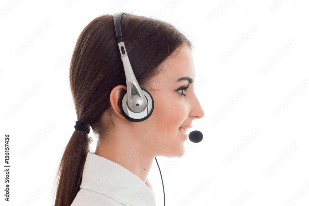 profile portrait of attractive brunette call center worker girl with headphones and microphone isolated on white background profile portrait of attractive brunette call center worker girl with headphones and microphone isolated on white background