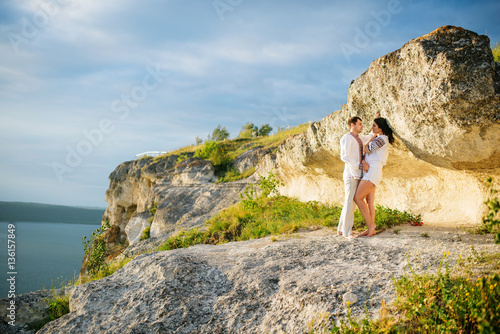 Couple wearing on dress with a pattern at beautiful landscape, o