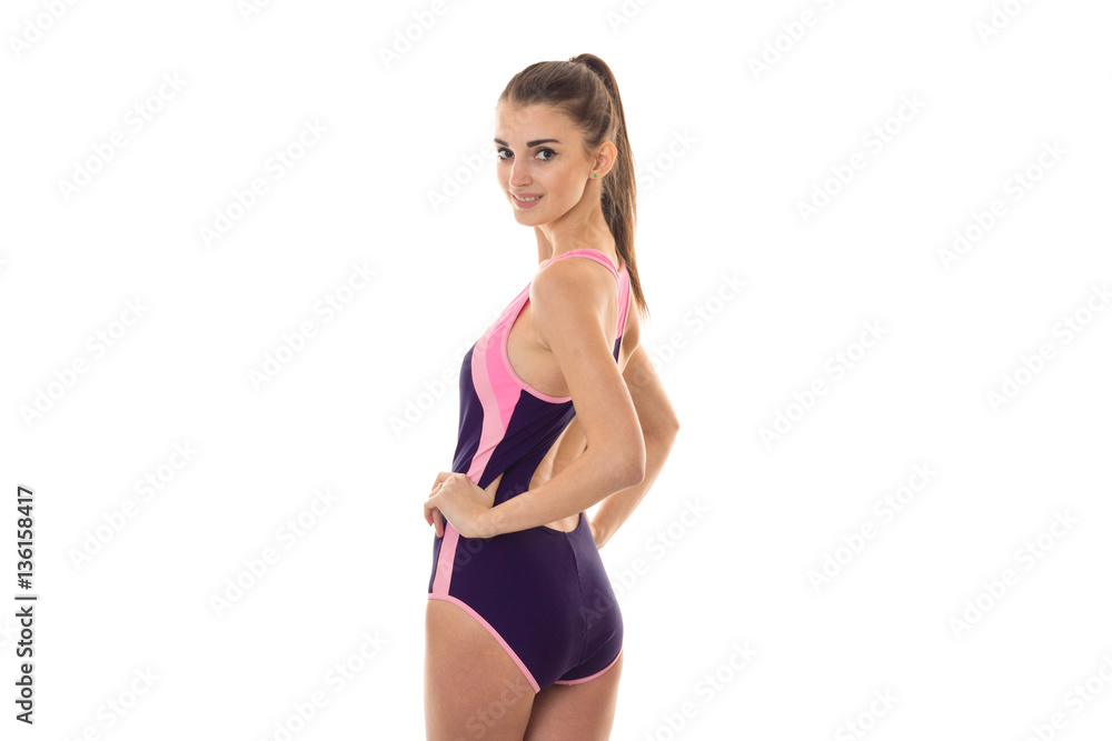 Slim sexy lady in body swimsuit looking at the camera and smiling isolated on white background