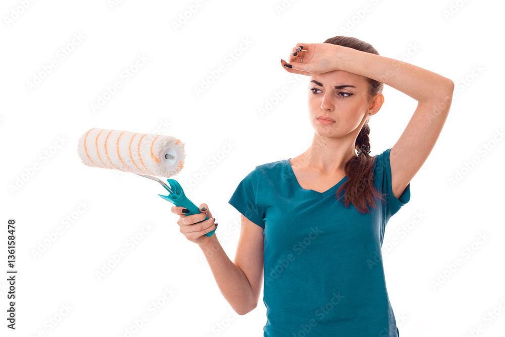 young brunette lady makes refurbish an apartment isolated on white background in studio young brunette lady makes refurbish an apartment isolated on white background in studio