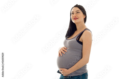 Young cheerful pregnant mother isolated on white background in studio posing