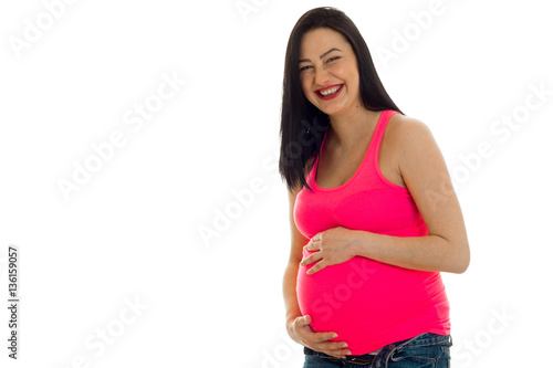 Young cheerful pregnant mother laughing isolated on white background in studio © ponomarencko