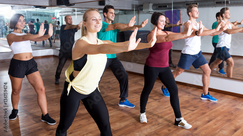 Adults having group fitness class