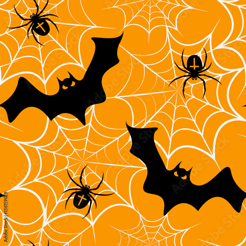 Seamless pattern with a bat, spiders and cobwebs Halloween on an orange background. photo