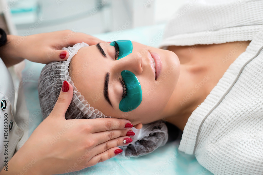 Cosmetic procedure, the woman's face with green flakes under the eyes. Cosmetic procedure, the woman's face with green flakes under the eyes.