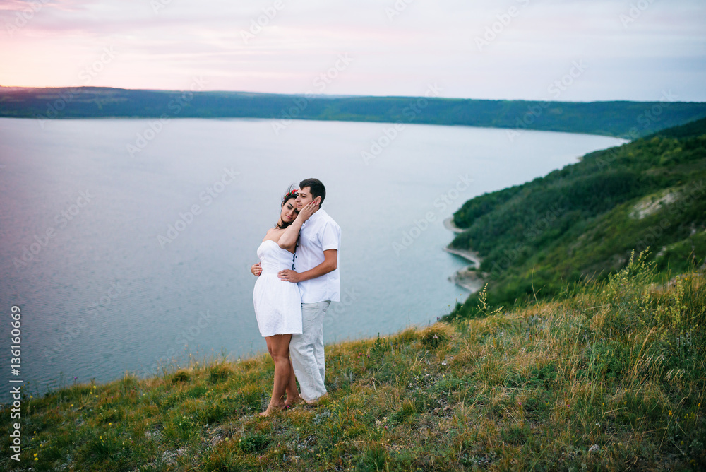 Loved couple in love at amazing landscape against cliff rocks. Loved couple in love at amazing landscape against cliff rocks.