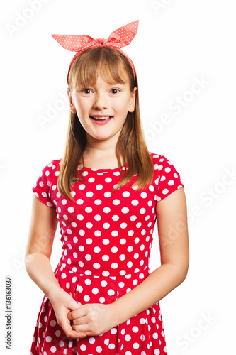 Studio shot of young little 9-10 year old girl, wearing red polka