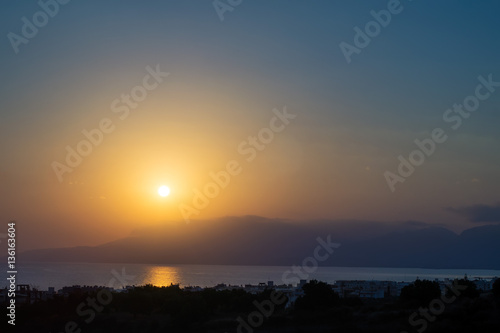 Hersonissos foggy sunrise with sun glade, Crete, Greece.