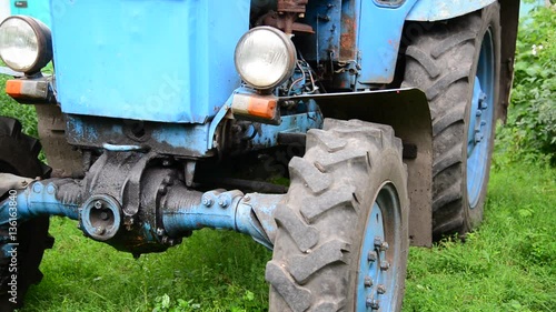 Blue old tractor in the village