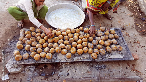 People are cooking traditional Indian food bafle on a festival occasion.