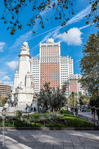Square of Spain in Madrid with Cervantes monument and skyscraper on background. Blue sky day