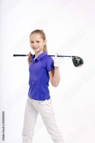 Pretty girl golfer posing with golf club on white backgroud in studio