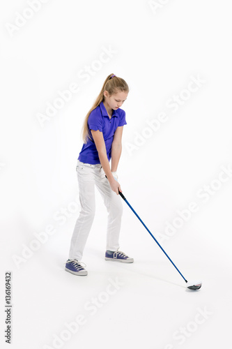 Pretty girl golfer swinging with diver on white backgroud in studio