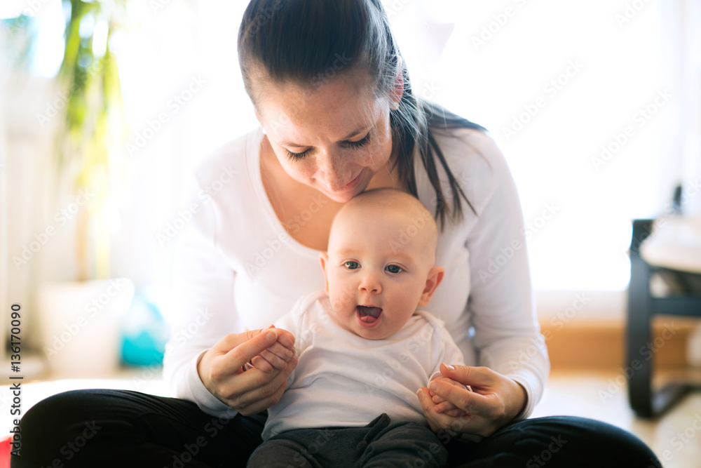 Beautiful mother holding her cute baby son Beautiful mother holding her cute baby son