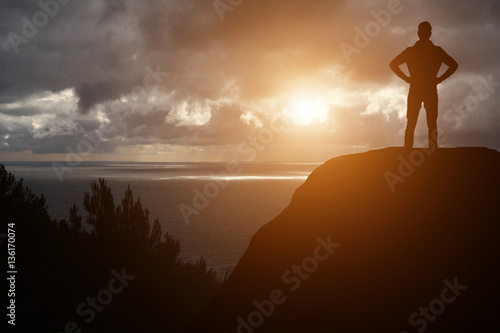 man against the sea standing on a mountain top looking into the distance © YURII Seleznov