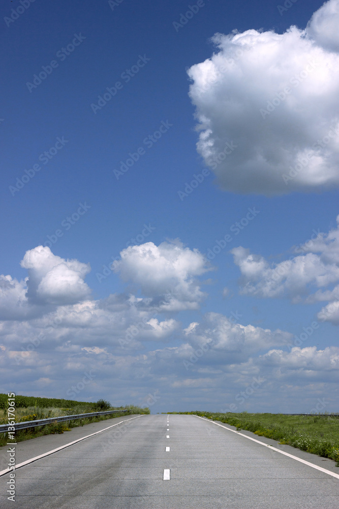Asphalt road over blue sky background. Asphalt road over blue sky background.