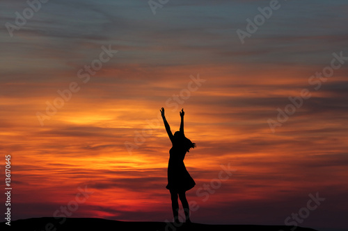 silhouette girl dancing on the background of a beautiful sunset
