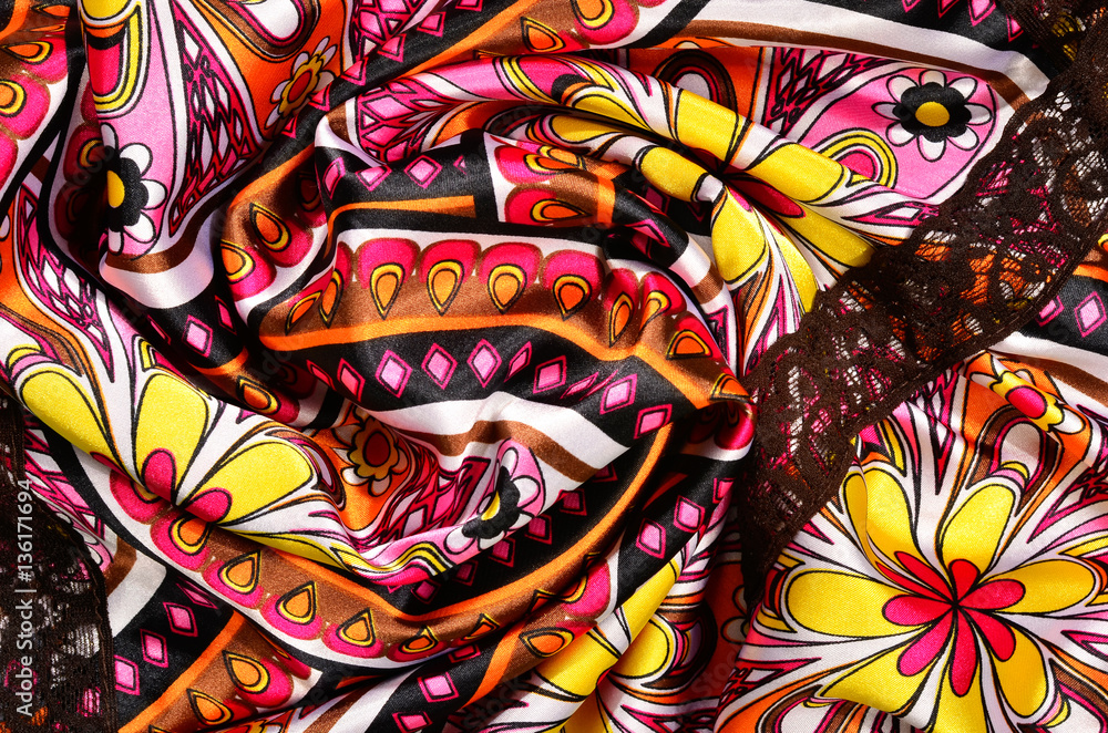 Floral and circles pattern with pink and yellow on folded satin Floral and circles pattern with pink and yellow on folded satin
