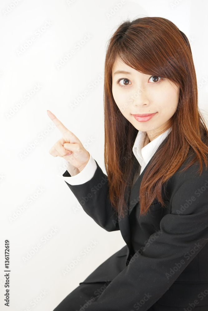 Young woman pointing something with white background Young woman pointing something with white background