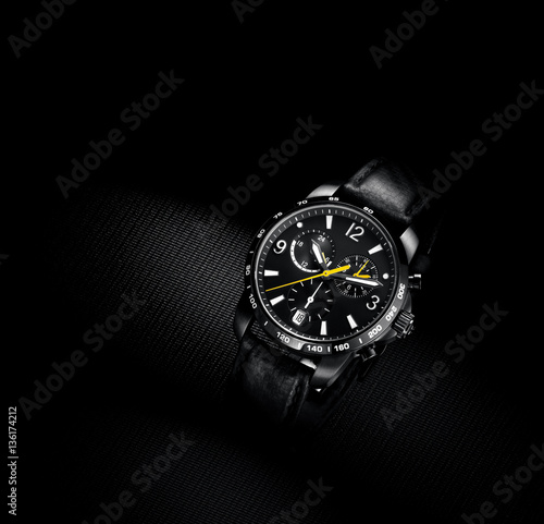 close up view of nice man's wrist watch on black background