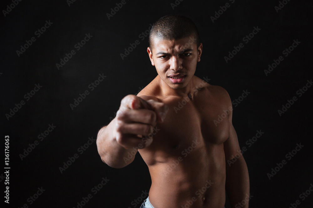 Angry shirtless african american man athlete pointing on you