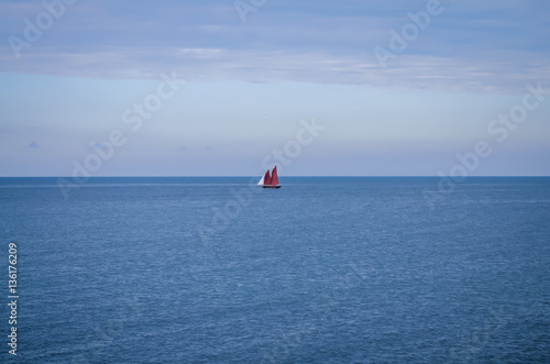 alone sailing boat floating over baltic sea