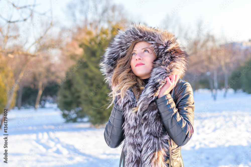 Girl in the park playing in the snow Girl in the park playing in the snow