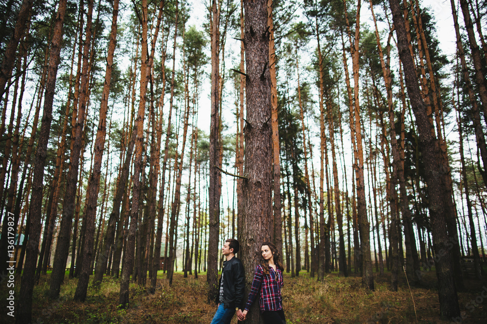 Young couple in love standing near the tree