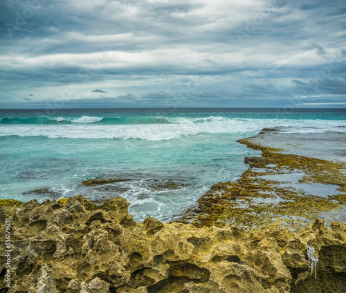 Beautiful eroded rocks on rugged ocean coastline. Stormy weather and rough seas