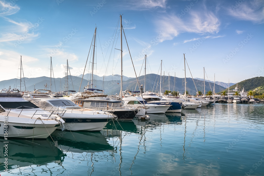 Yachts at the pier against mountains at dawn