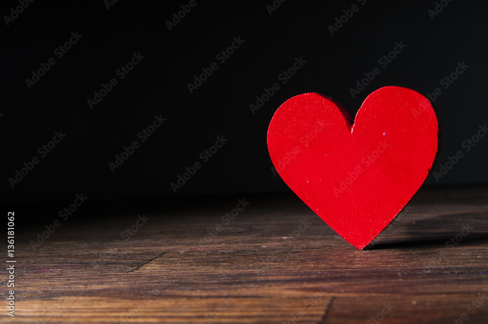 Red wooden heart on a wooden background. Space for text Red wooden heart on a wooden background. Space for text