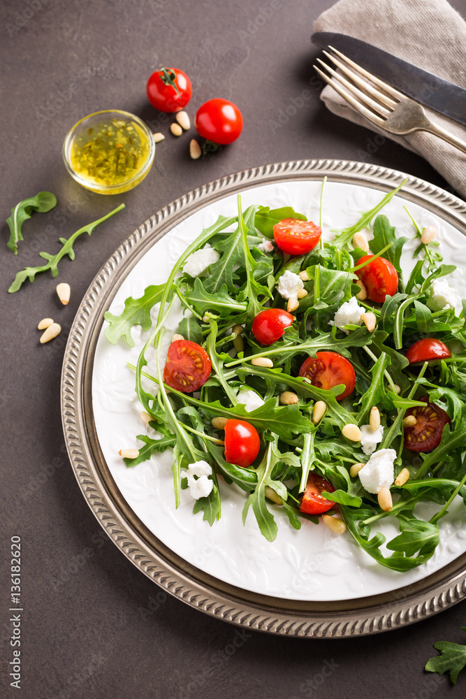 fresh vegetable salad with rucola, tomatos and goat cheese. Healthy food concept. fresh vegetable salad with rucola, tomatos and goat cheese. Healthy food concept.